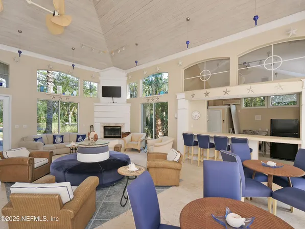 a room with gym equipment and large windows