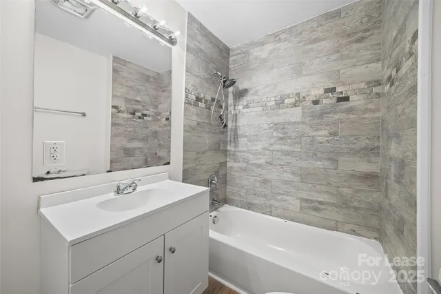 a bathroom with a sink mirror toilet and bathtub