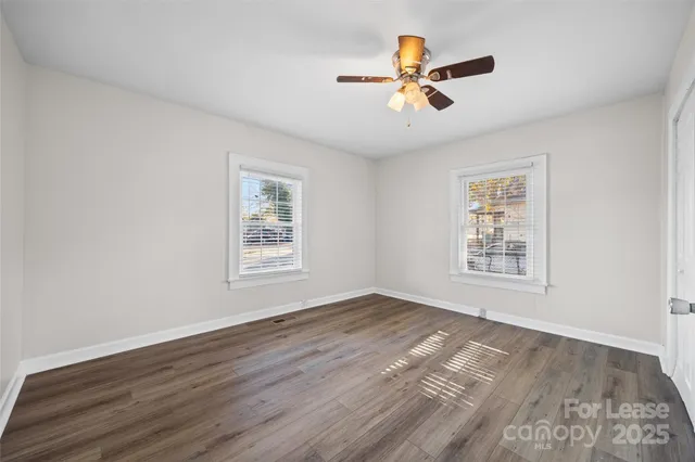 a view of a room with wooden floor and a window