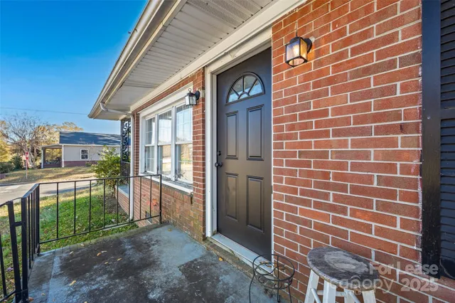 a view of a brick house with a large window