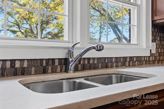 a view of a kitchen sink sitting area in front of a window