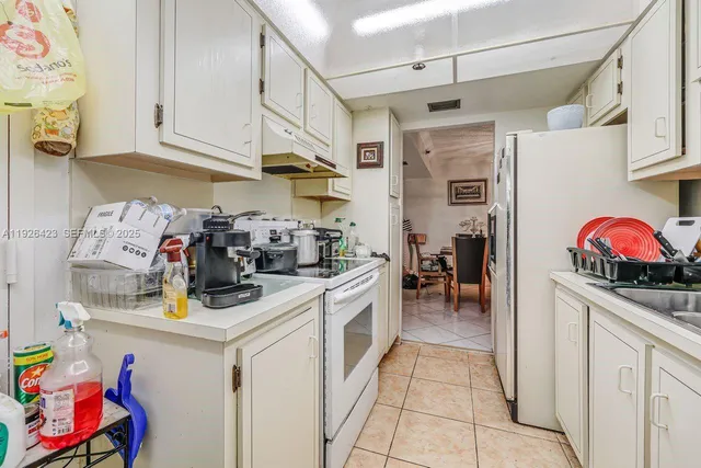 a kitchen with stainless steel appliances granite countertop a sink and dishwasher