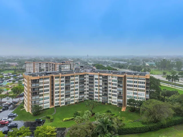 a view of a hallway with a livingroom and dining room space
