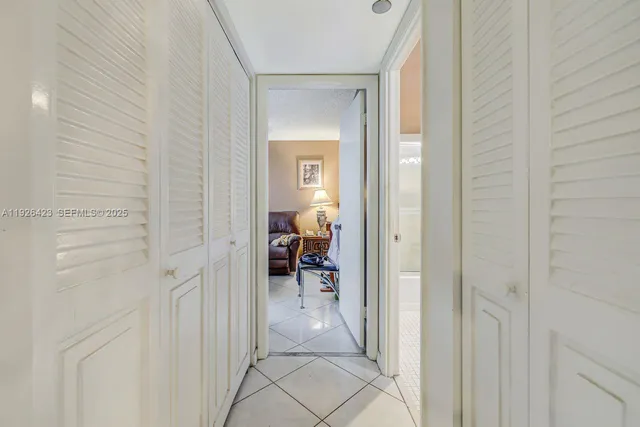 a bedroom with bed and a chandelier