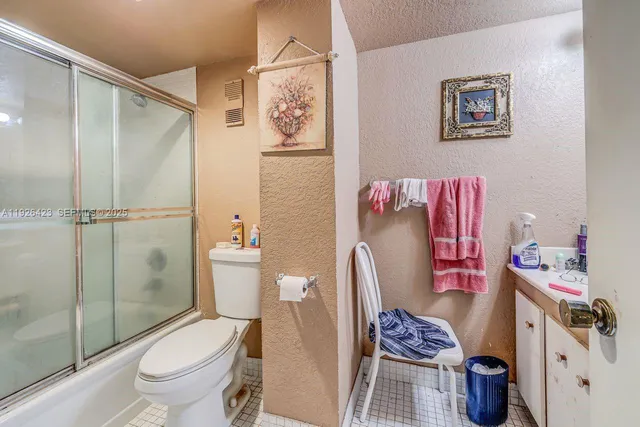 a white toilet sitting next to a bathroom