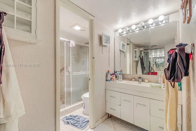 a view of walk in closet and bathroom