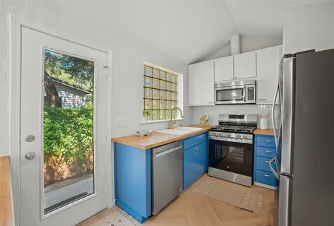 a kitchen with stainless steel appliances granite countertop a refrigerator stove and sink