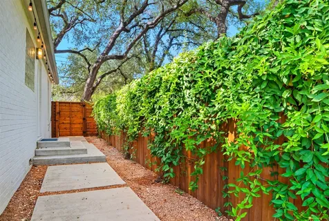 a pathway of a house with a yard