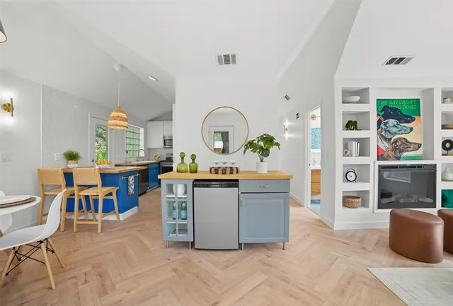a living room with furniture a rug and white walls