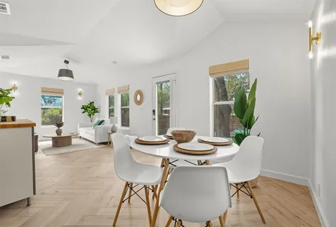 a view of a dining room with furniture window and wooden floor