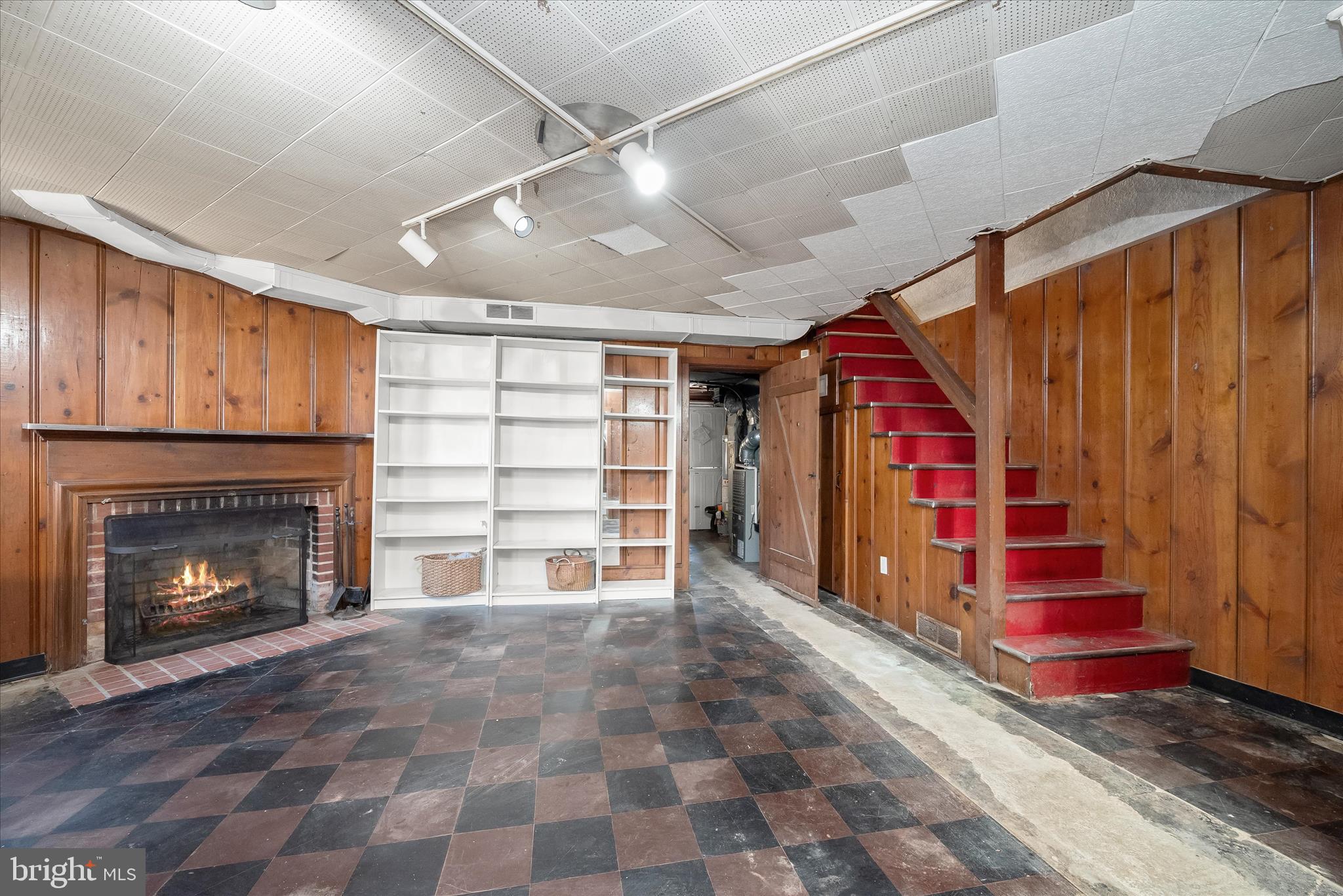 1509 Shadyside Road Baltimore, MD 21218 - Photo 28 of 38 a view of an empty room with wooden floor fireplace and a window