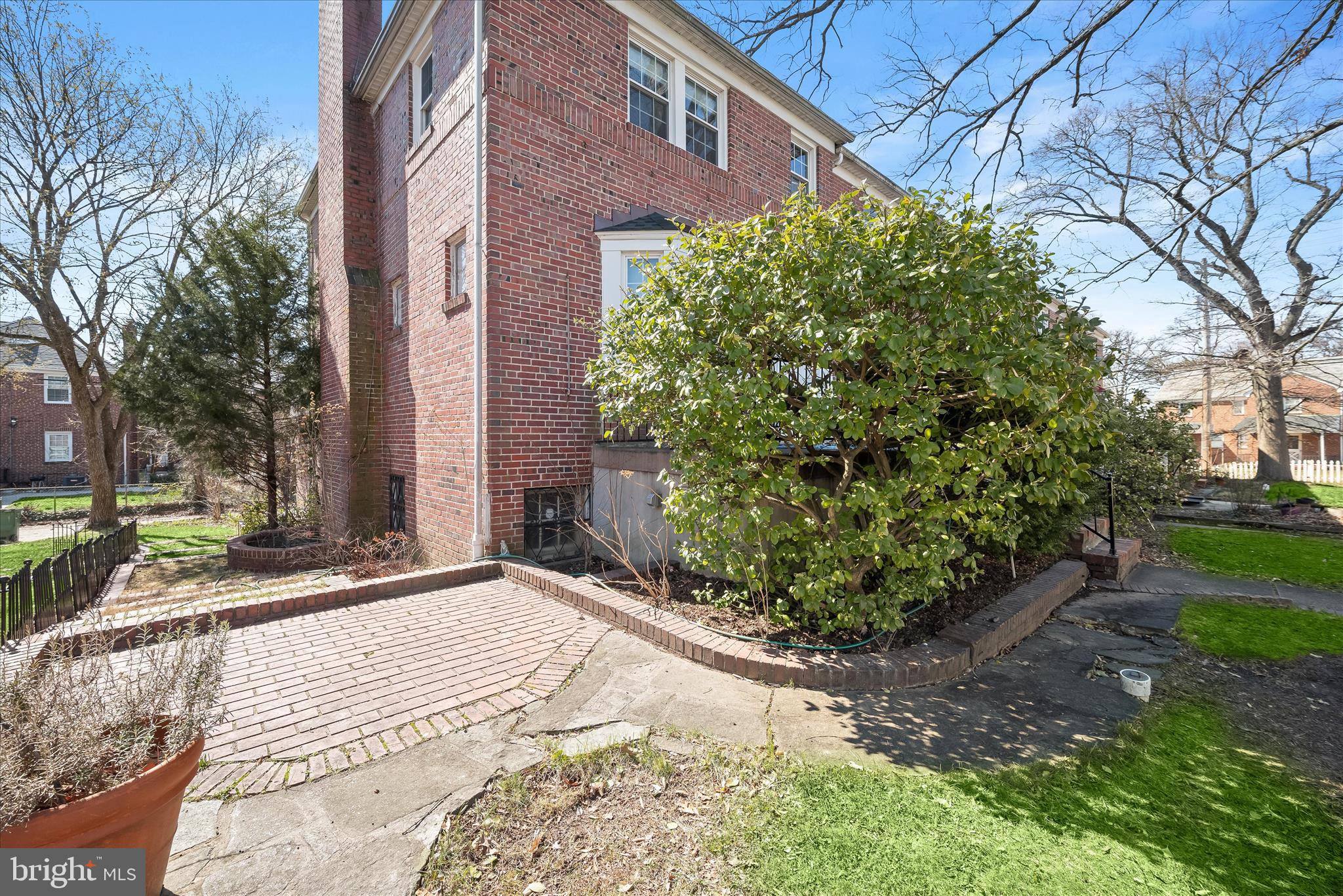 1509 Shadyside Road Baltimore, MD 21218 - Photo 33 of 38 a view of a backyard with potted plants and large trees
