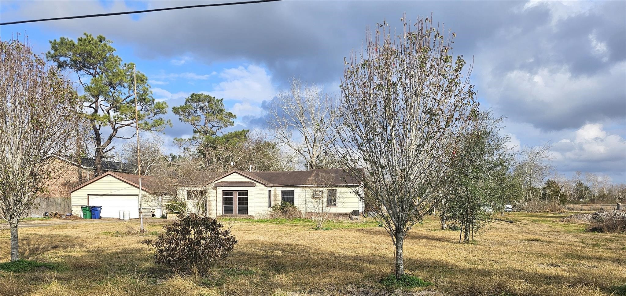 2025 Shanks Road Angleton, TX 77515 - Photo 1 of 5 a front view of a house with a yard and trees