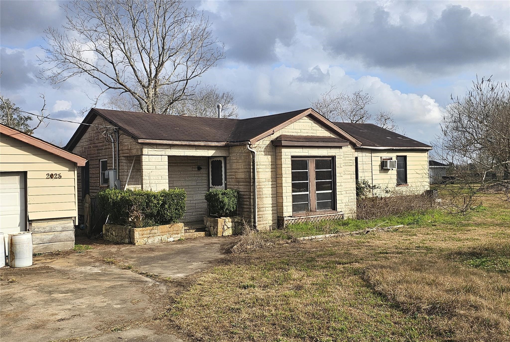 2025 Shanks Road Angleton, TX 77515 - Photo 2 of 5 a front view of a house with a yard and potted plants