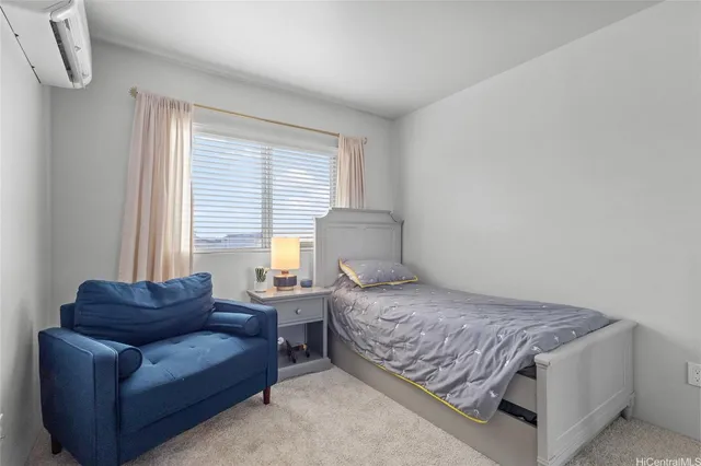 a bedroom with a bed couch and window