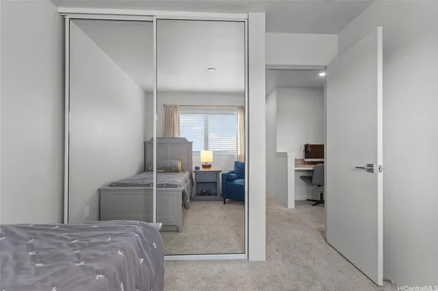 a bedroom with a bed and a view of bathroom