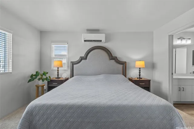 a bedroom with bed and a mirror on dresser