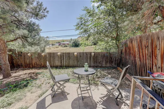 a backyard of a house with table and chairs
