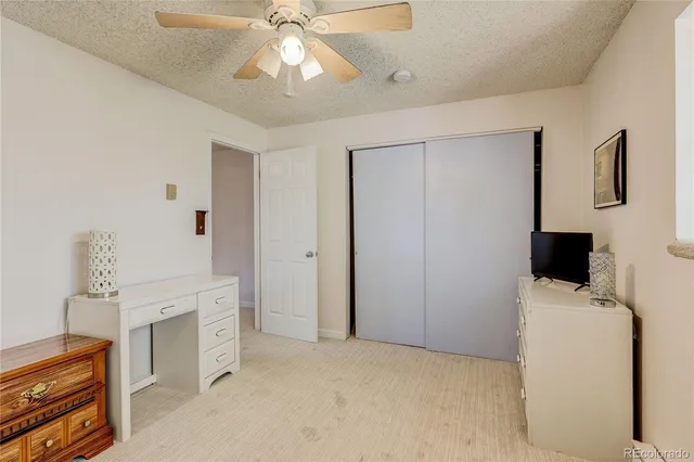 a bathroom with a granite countertop sink mirror vanity and toilet