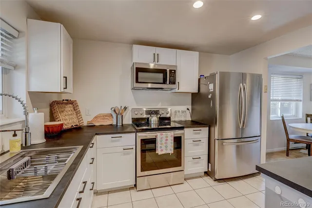 a kitchen with a stove a refrigerator and a sink