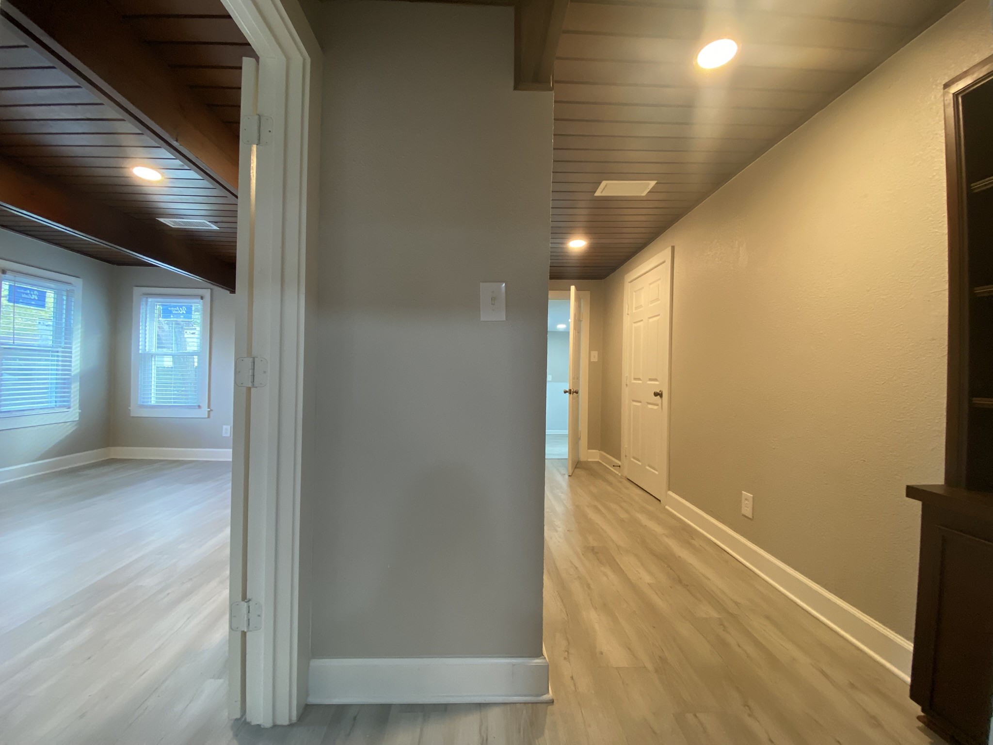 628 King Street Houston, TX 77022 - Photo 11 of 24 Leaving the kitchen, the the left is the primary room and to the right hallway leads to large primary bathroom and utility room.