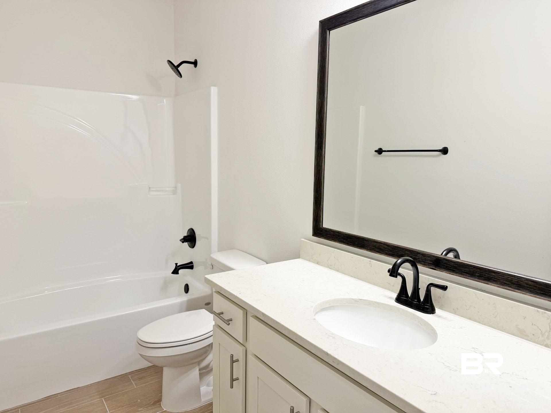 1753 Breckinridge Place Foley, AL 36535 - Photo 21 of 24 Bathroom featuring a white vanity with a light-toned countertop, an undermount sink, and matte black fixtures