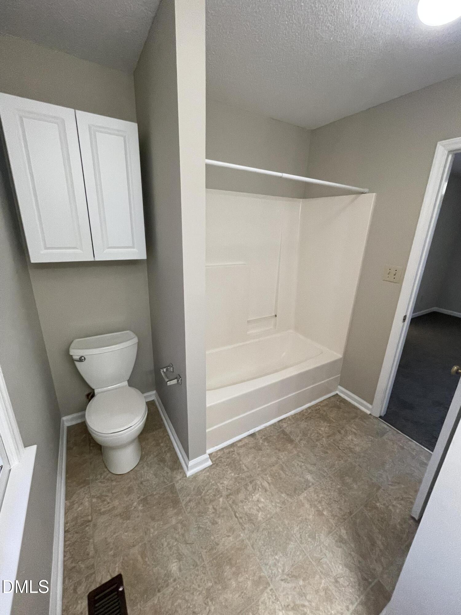4116 Lodge Allen Court Raleigh, NC 27616 - Photo 13 of 20 a bathroom with a toilet and a bathtub