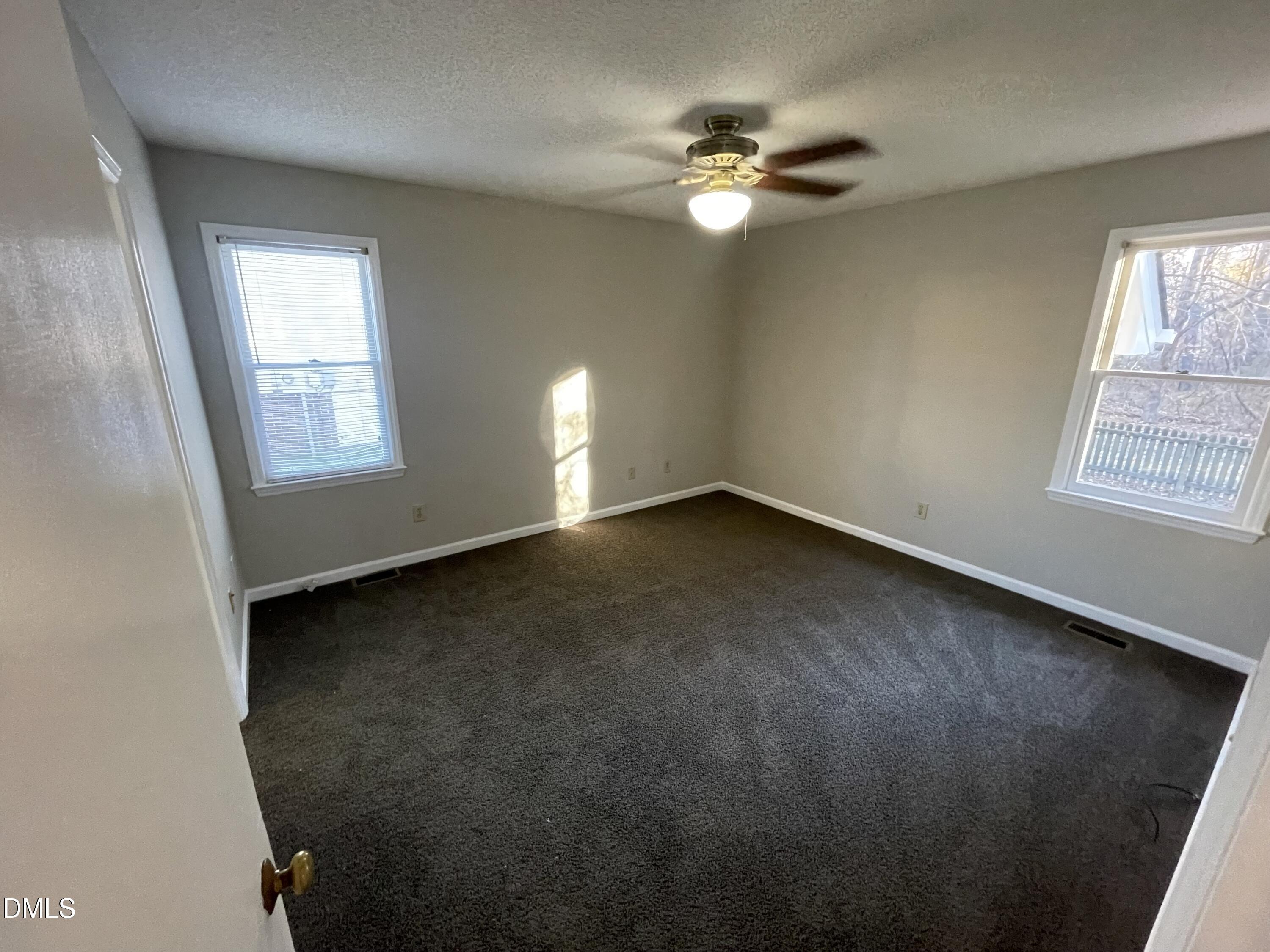 4116 Lodge Allen Court Raleigh, NC 27616 - Photo 15 of 20 an empty room with windows and fan