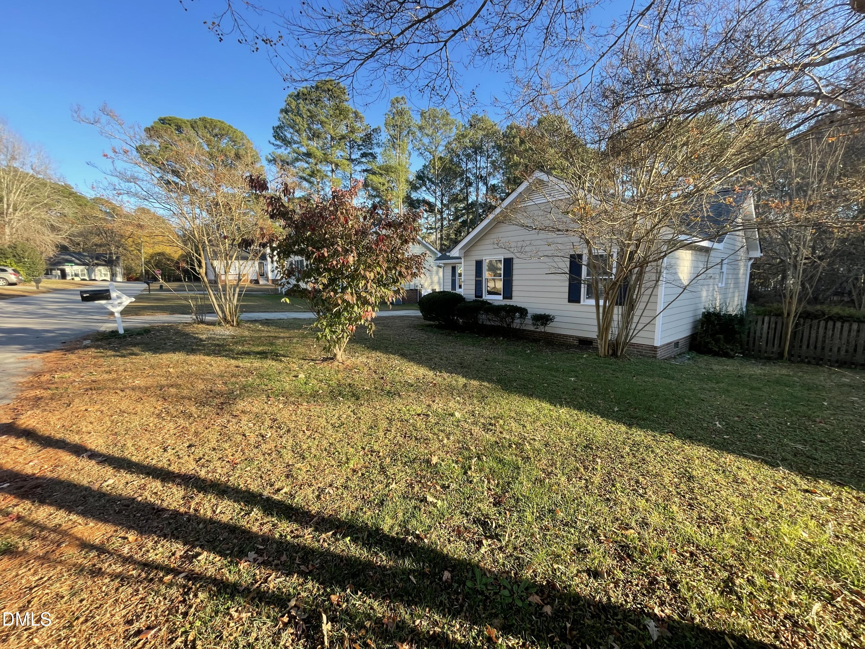 4116 Lodge Allen Court Raleigh, NC 27616 - Photo 2 of 20 a yellow house sitting in middle of the middle of a yard