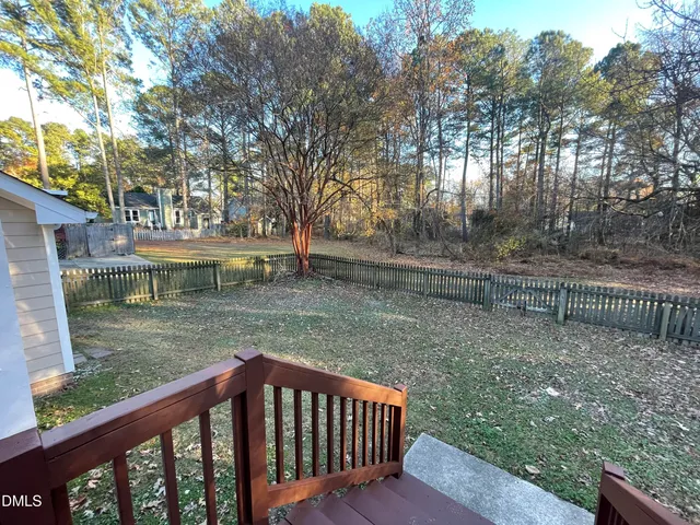 a view of a wooden deck with a backyard
