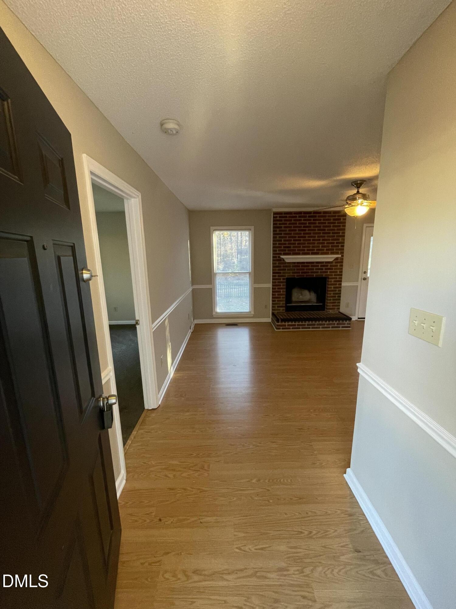4116 Lodge Allen Court Raleigh, NC 27616 - Photo 8 of 20 a view of a livingroom with wooden floor and a fireplace