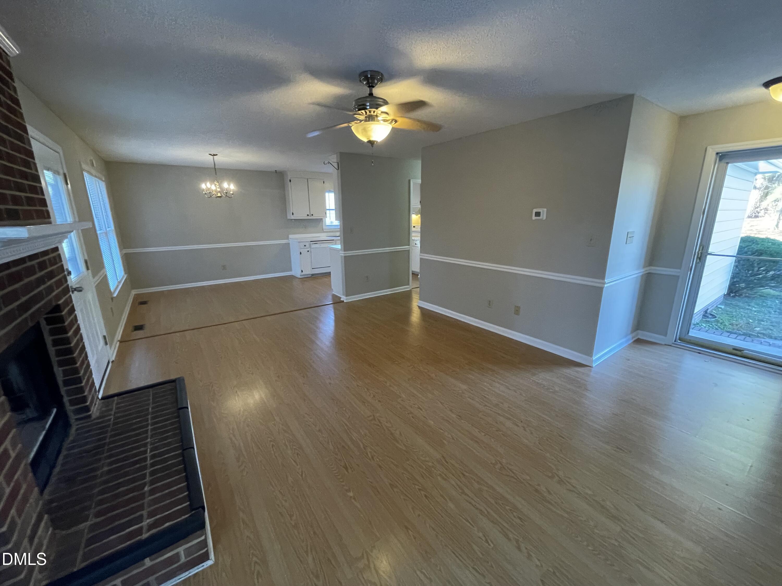 4116 Lodge Allen Court Raleigh, NC 27616 - Photo 9 of 20 a view of an empty room with wooden floor and a window