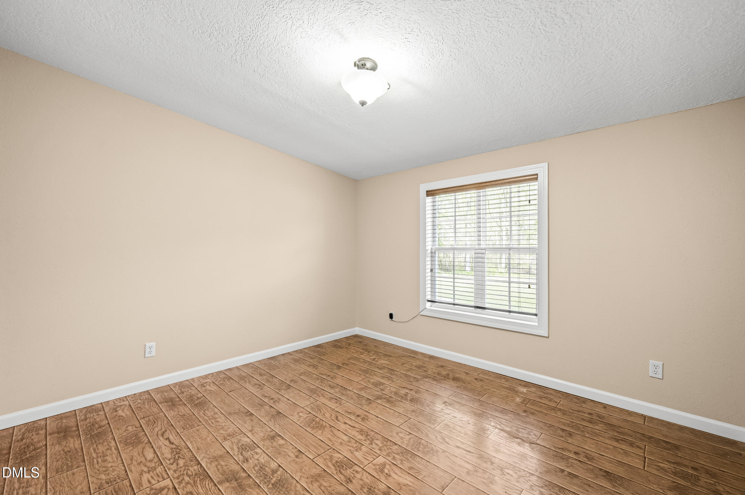 221 Pinkney Church Road Fremont, NC 27830 - Photo 12 of 36 an empty room with wooden floor and windows