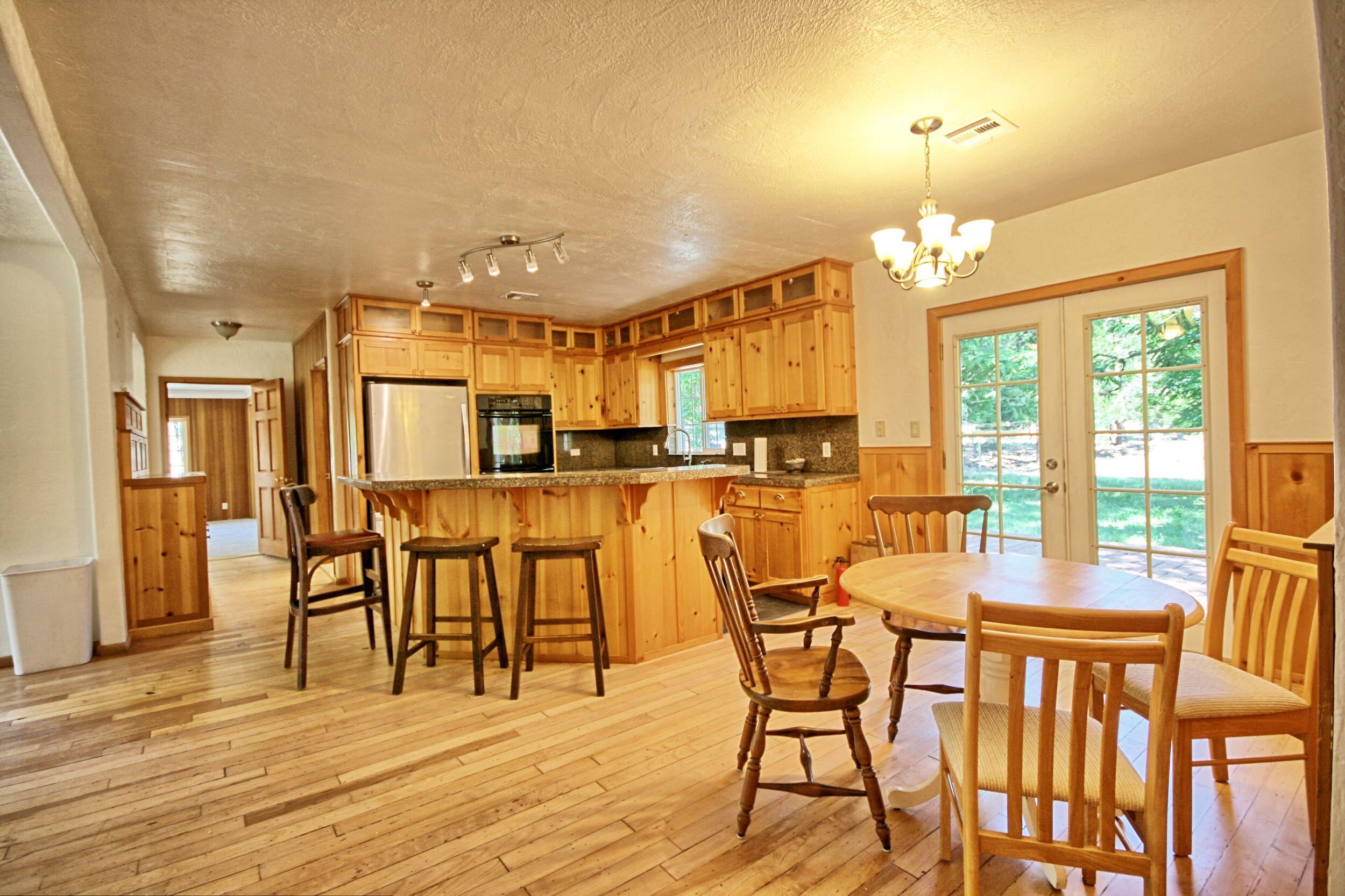 199 Powell Creek Road Williams, OR 97544 - Photo 19 of 57 a view of a dining room with furniture and wooden floor