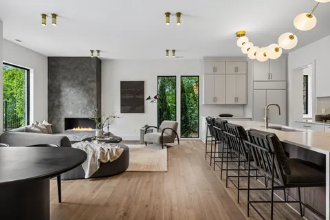 a large kitchen with lots of counter space a sink appliances and a large window