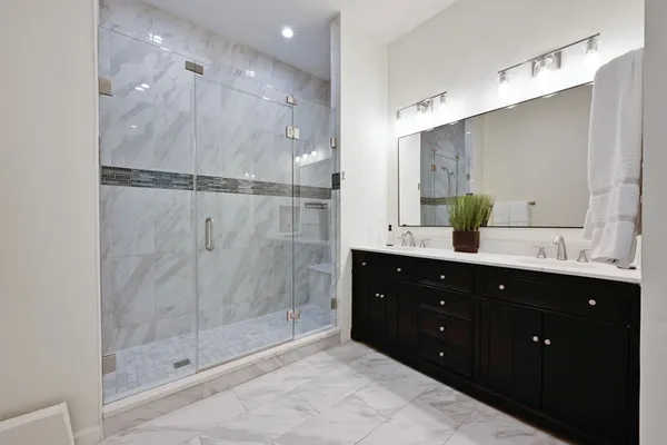 a bathroom with a shower sink and mirror