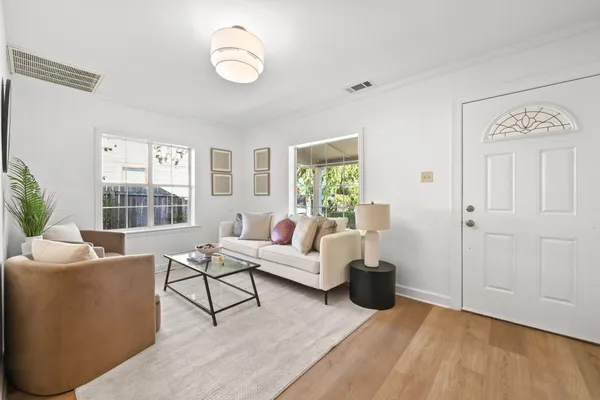 a living room with furniture and wooden floor