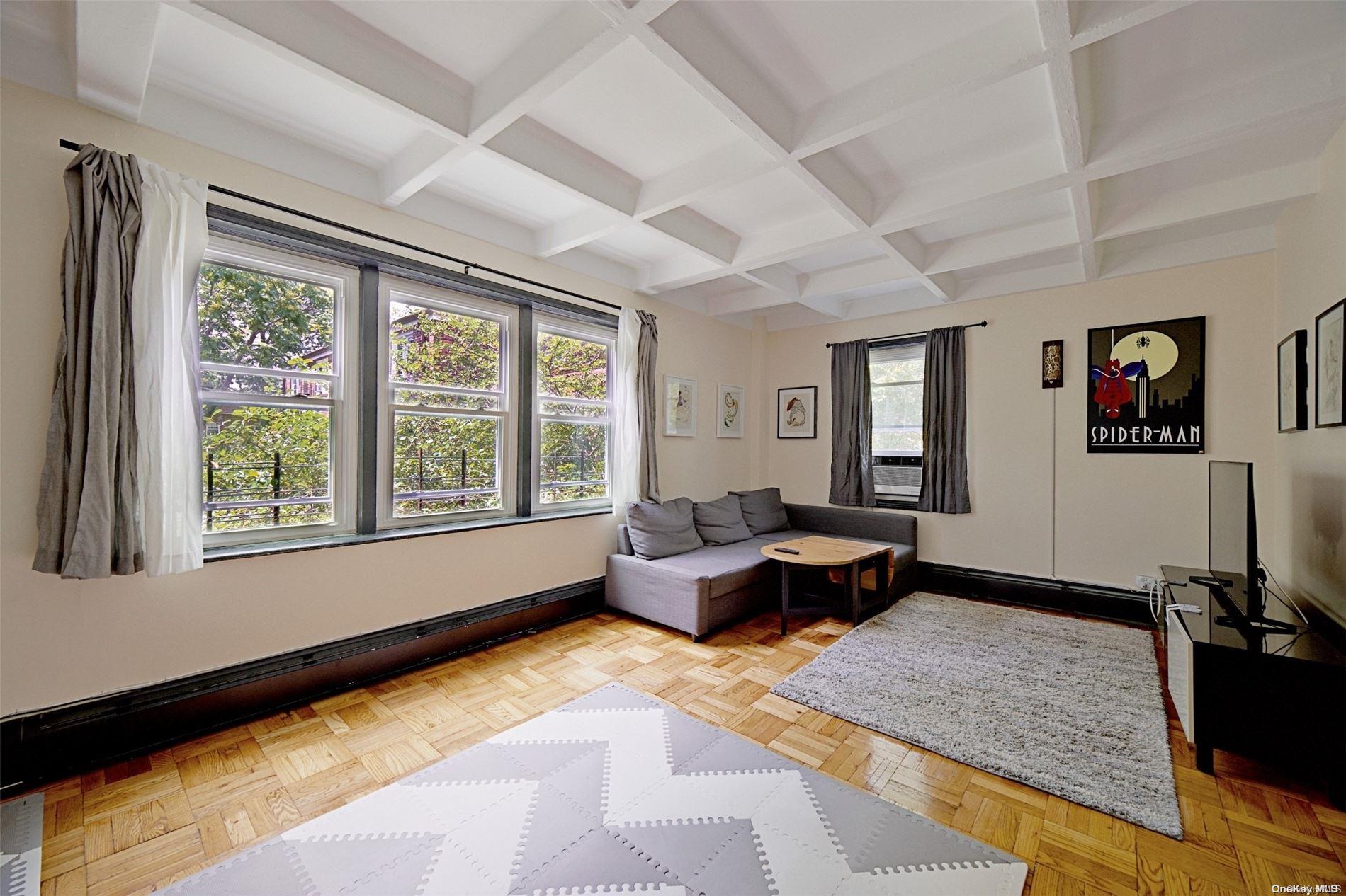 a living room with furniture and floor to ceiling window