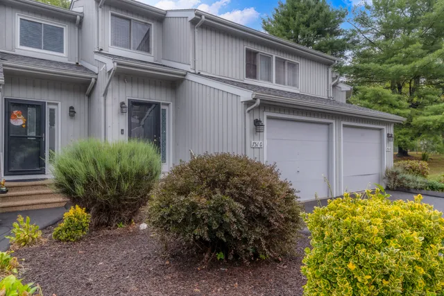 a view of a house with a small yard and plants