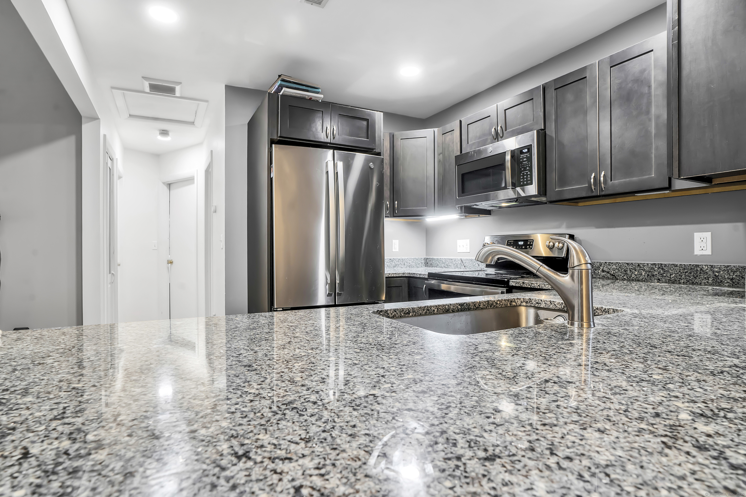 751 West Main Street, Unit G Cheshire, CT 06410 - Photo 15 of 38 a kitchen with stainless steel appliances granite countertop a refrigerator a stove and a sink