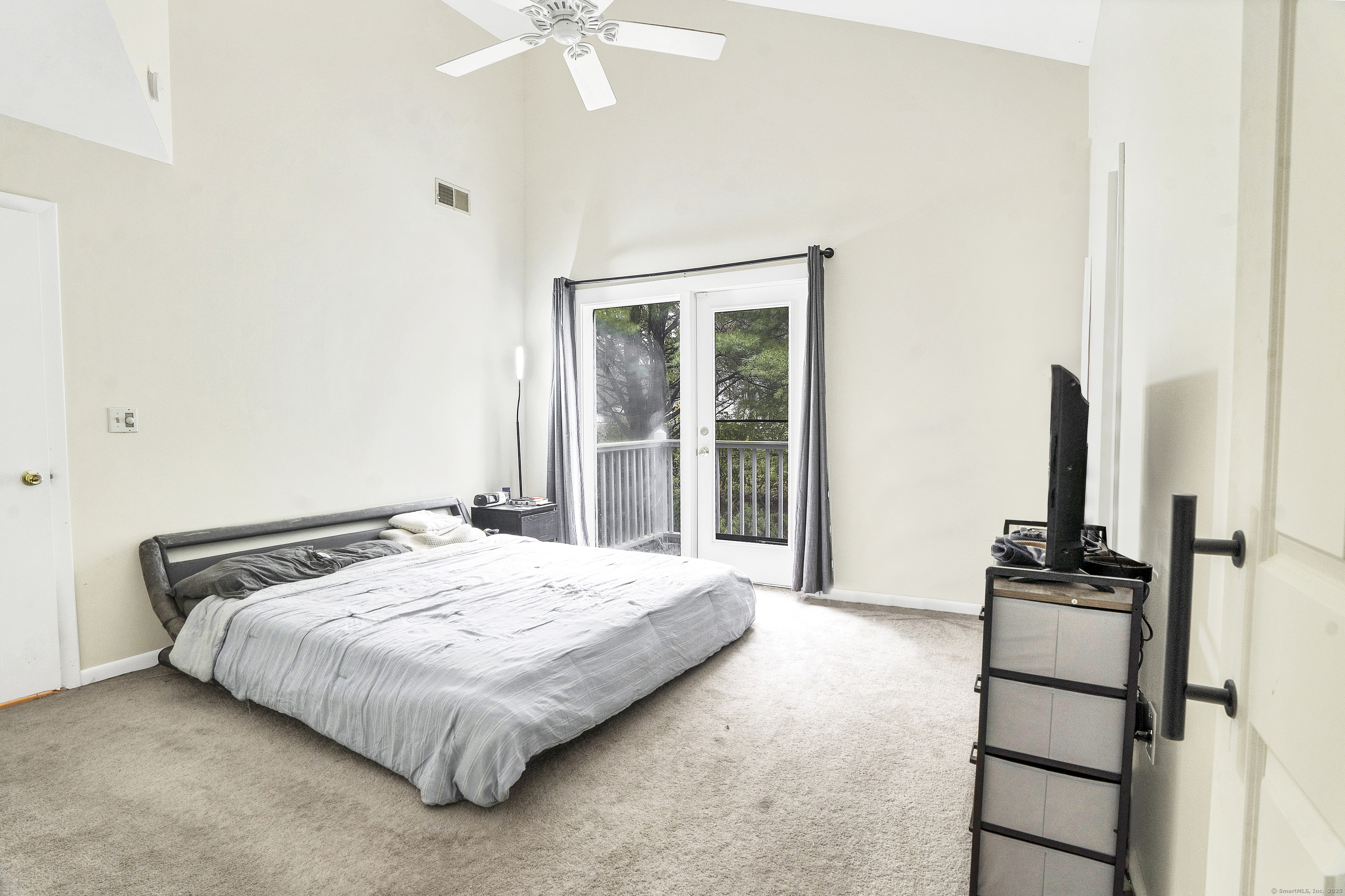 751 West Main Street, Unit G Cheshire, CT 06410 - Photo 19 of 38 a bedroom with a bed and a chandelier