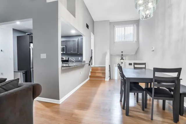 a living room with stainless steel appliances kitchen island granite countertop furniture and a flat screen tv