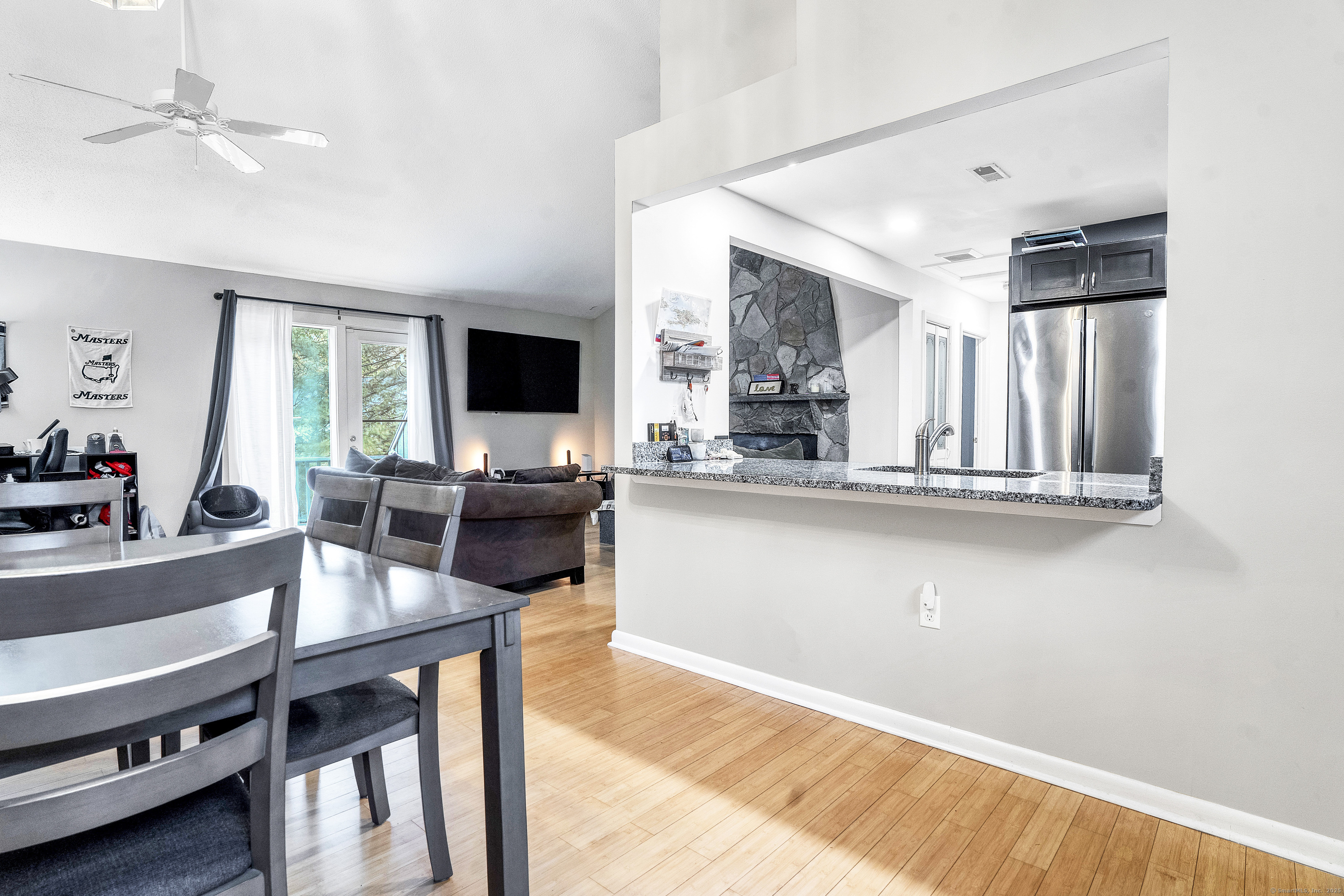 751 West Main Street, Unit G Cheshire, CT 06410 - Photo 8 of 38 a living room with stainless steel appliances kitchen island granite countertop furniture and a flat screen tv