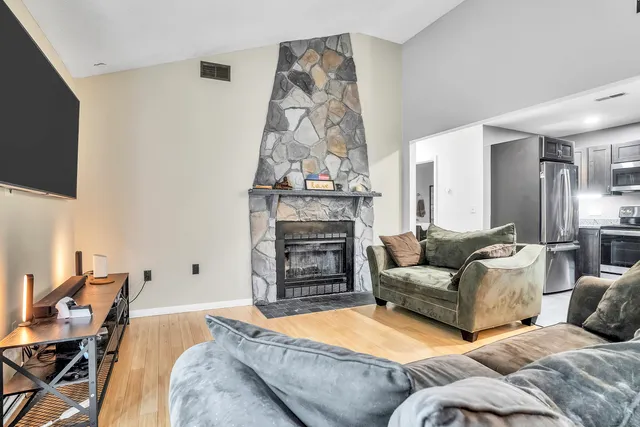 a kitchen with stainless steel appliances granite countertop a refrigerator a stove and a sink