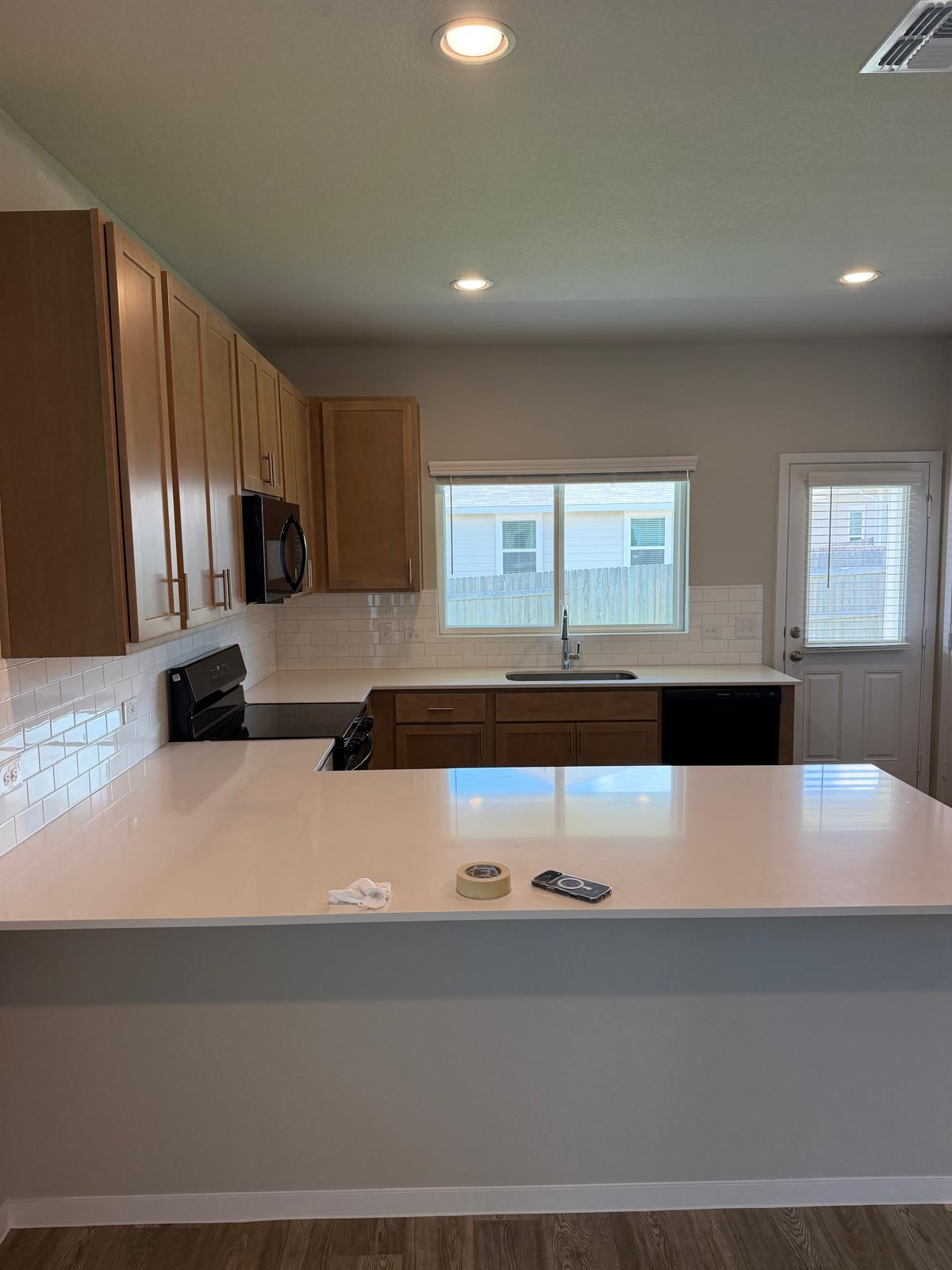 2701 Towy Road Manor, TX 78653 - Photo 12 of 35 A well-appointed kitchen features ample counter space, rich cabinetry, and a generous island for culinary endeavors.