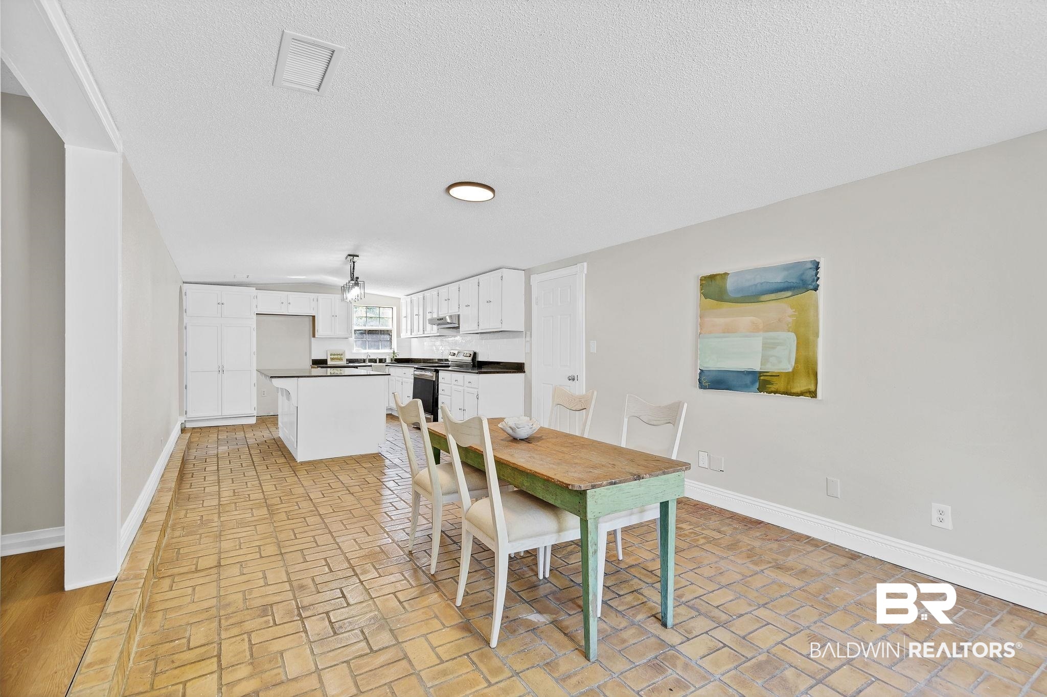 11964 Stroh Road Daphne, AL 36527 - Photo 21 of 58 Dining area featuring brick floor, visible vents, baseboards, and a textured ceiling