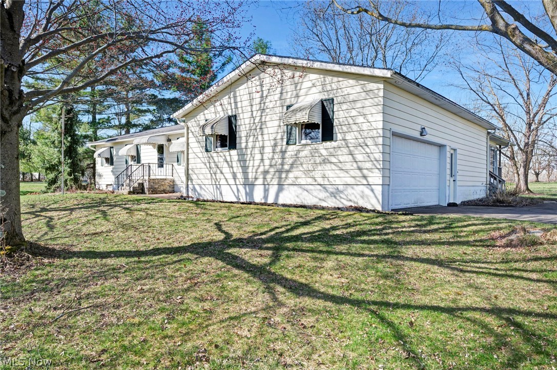 6452 Carsten Road Medina, OH 44256 - Photo 32 of 41 View of property exterior featuring a garage and a yard