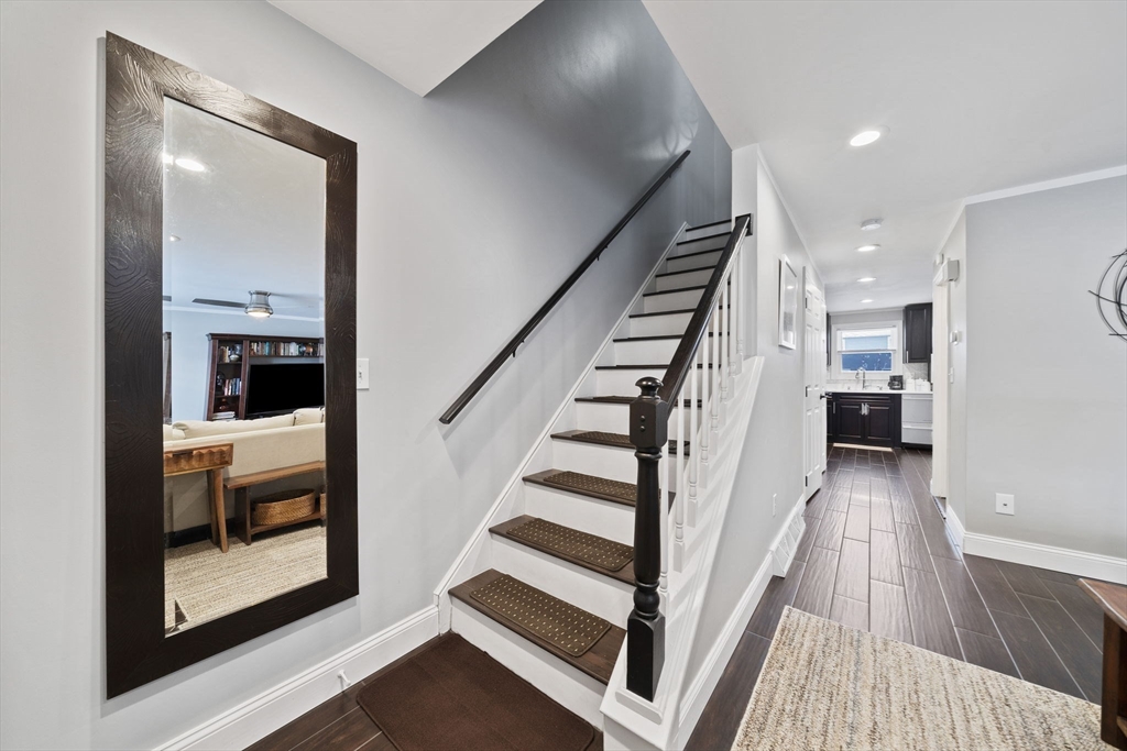 4 F Franklin Square, Unit 4F Randolph, MA 02368 - Photo 13 of 26 a view of a hallway with wooden floor and staircase