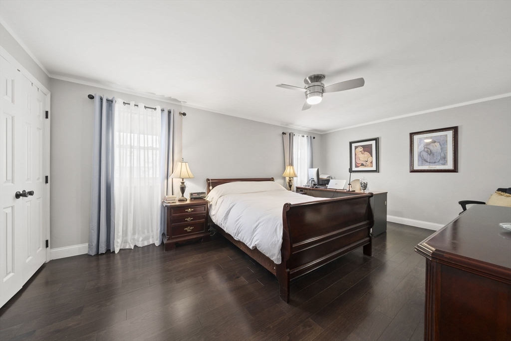 4 F Franklin Square, Unit 4F Randolph, MA 02368 - Photo 14 of 26 a bedroom with a bed and wooden floor