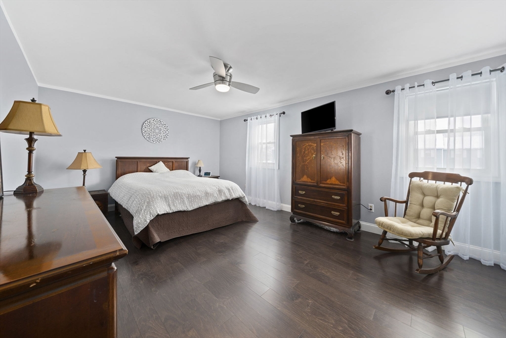 4 F Franklin Square, Unit 4F Randolph, MA 02368 - Photo 19 of 26 a bedroom with furniture and a flat screen tv